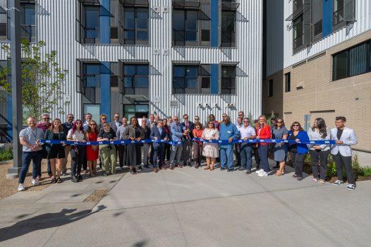 DHA staff cutting the ribbon at the opening of Flo apartments in Sun Valley.