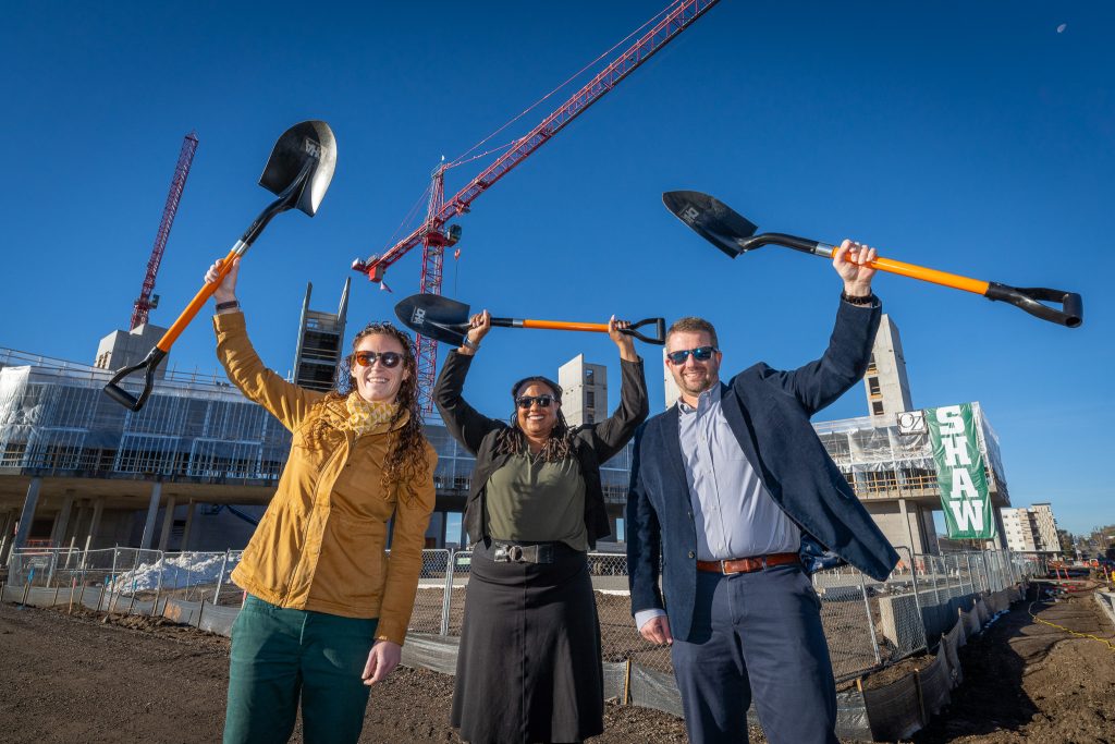 Denver Housing Authority leaders hold their shovels in the air celebrating at the Sun Valley Groundbreaking Ceremony