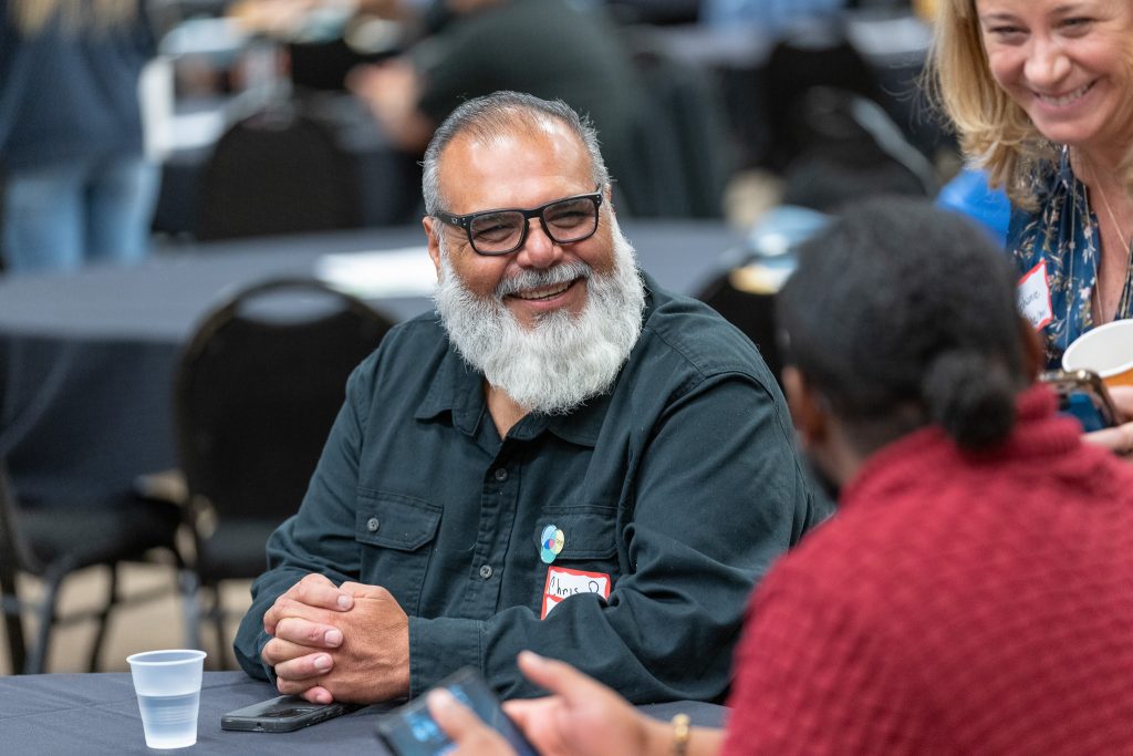 Denver Housing Authority Coworkers laughing together at the Annual Business Meeting.